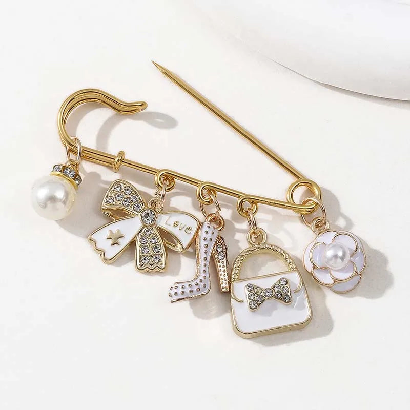 Gold-toned elegant alloy brooch pin featuring a pearl, bow, and white rectangular charm.