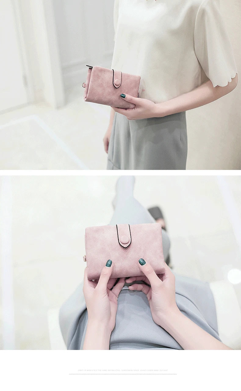 A woman holds a pink frosted card wallet with a silver strap in a light indoor setting.