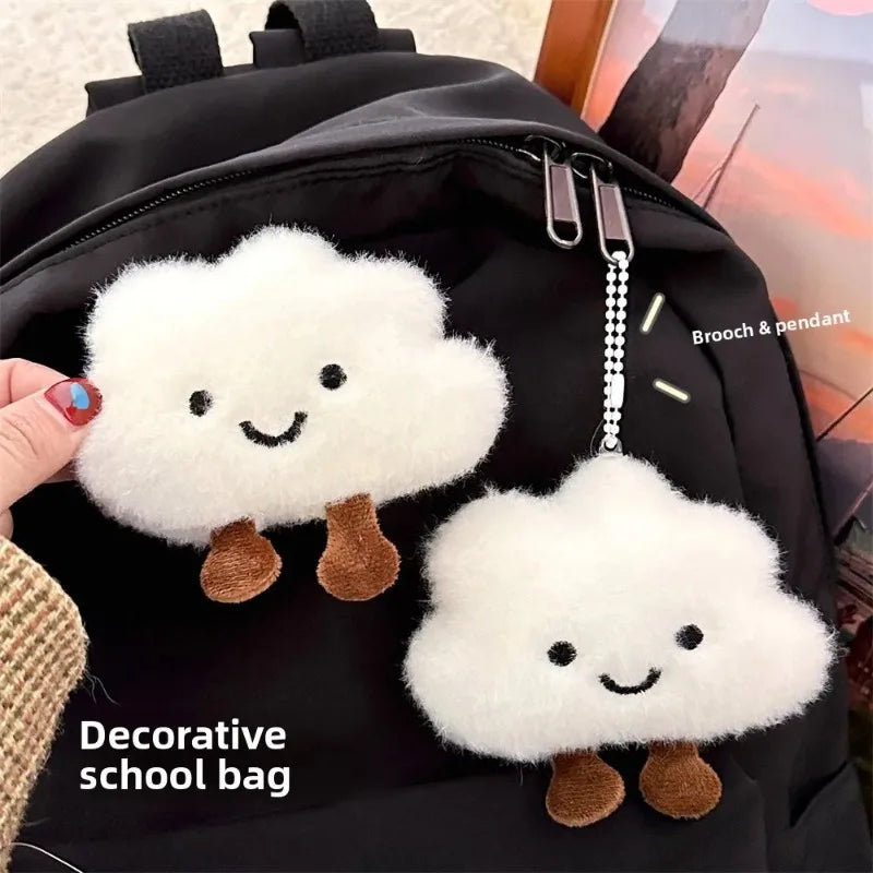 Black school bag featuring white cloud shaped plush keychains and brooch pins