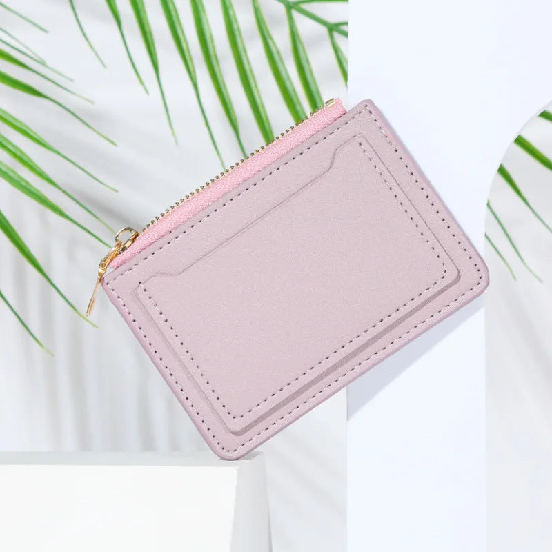 A light pink PU leather mini card holder wallet with a gold zipper, shown against a white background.