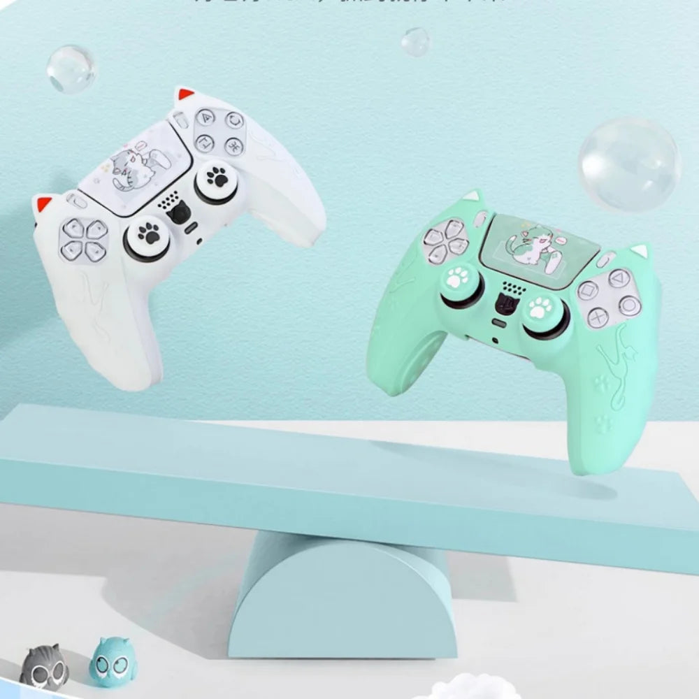 A light green silicone grip cover for a PlayStation controller featuring a cat design, displayed on a blue surface.
