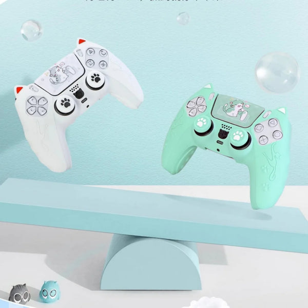 A light green silicone grip cover for a PlayStation controller featuring a cat design, displayed on a blue surface.