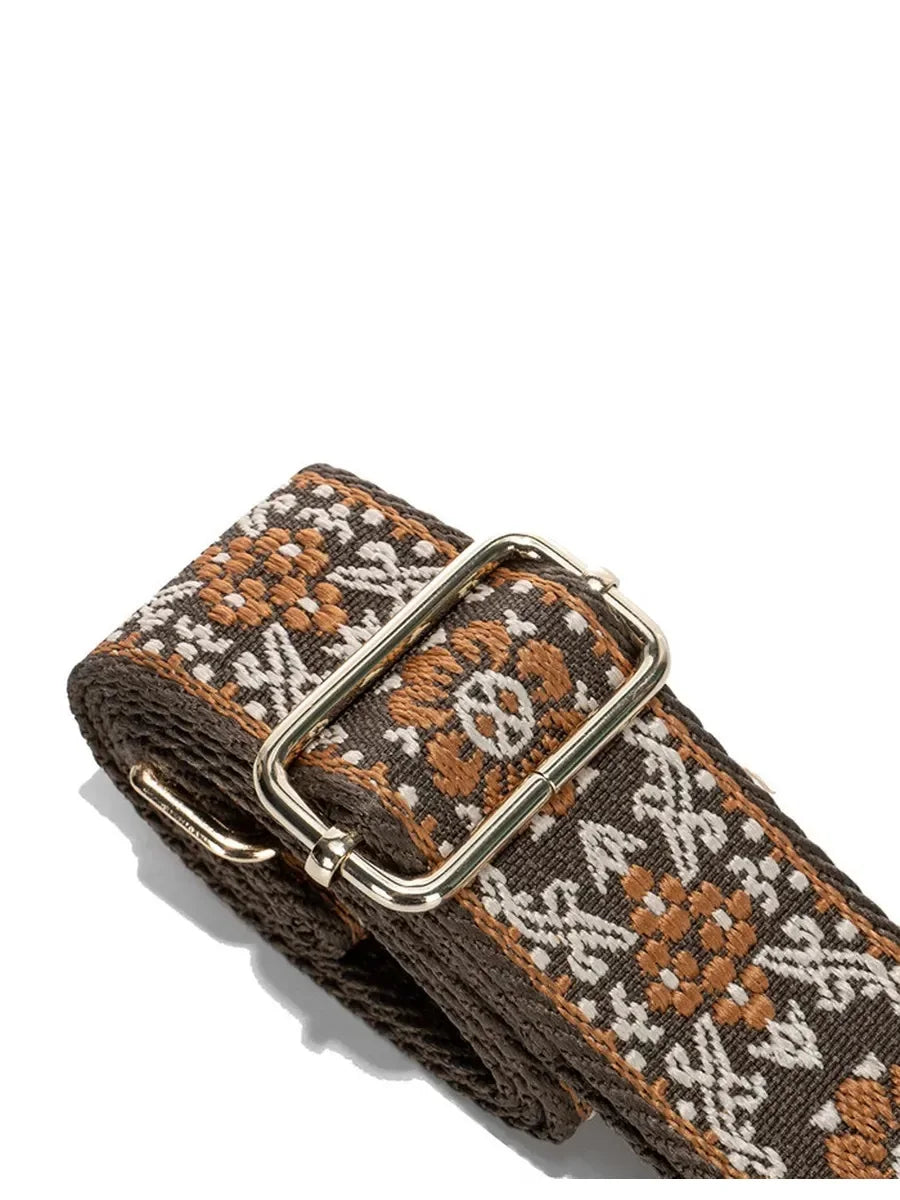 A close-up of a brown textile replacement bag strap featuring an orange and white geometric pattern.