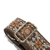 A close-up of a brown textile replacement bag strap featuring an orange and white geometric pattern.