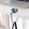Silver pendant with a marbled blue and green stone attached to a black leather strap for a portable bag hook