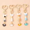 Gold-toned starfish and seashell keychain with pearl and striped accents