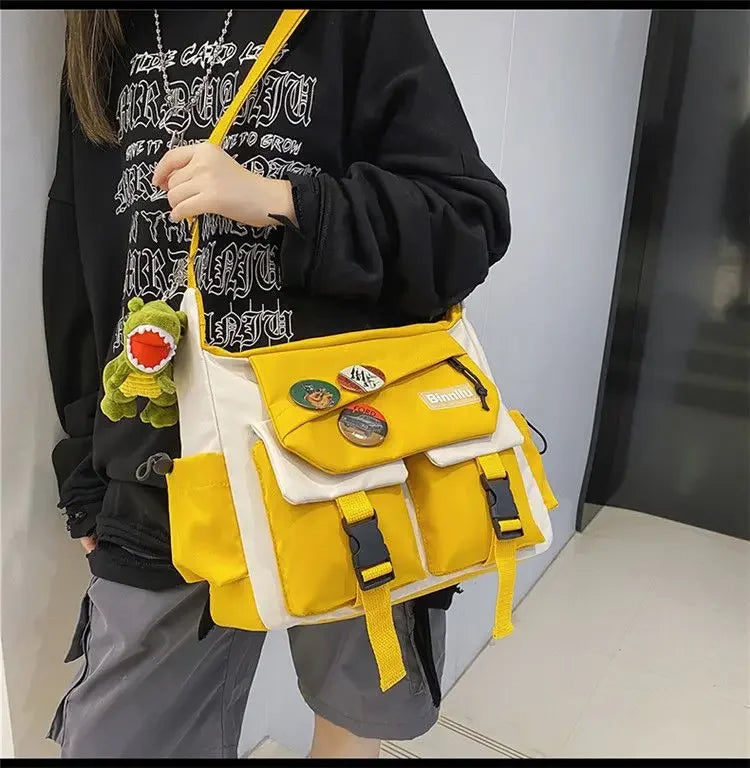 A woman holds a yellow and white nylon crossbody shoulder bag with black accents.