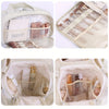A beige portable side-zip cosmetic organizer bag showing various makeup brushes and beauty tools inside.