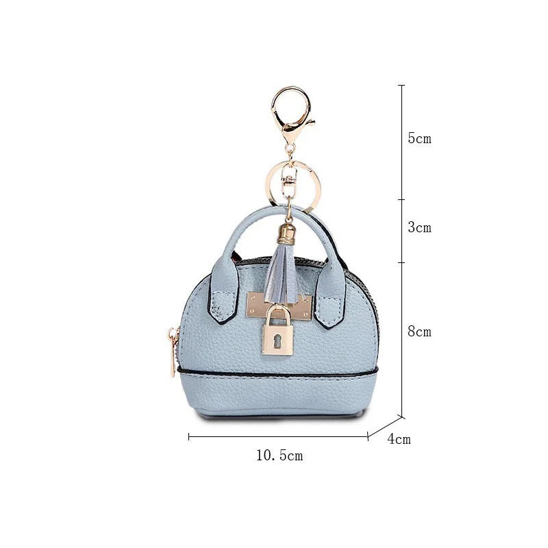 Light blue portable earbud case with a gold keychain charm