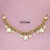 Gold chain necklace with white flower charms and a gold clasp, measuring 24.5cm.