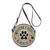A round black crossbody bag featuring a cartoon cat silhouette design.