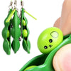 Green silicone fidget toy keychains hanging from a clip and resting on a green plastic holder