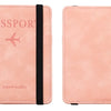 A pink leather passport wallet with a black strap and the word passport printed on it.
