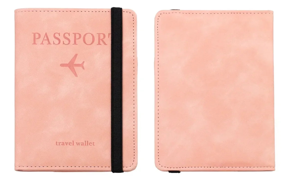 A pink leather passport wallet with a black strap and the word passport printed on it.