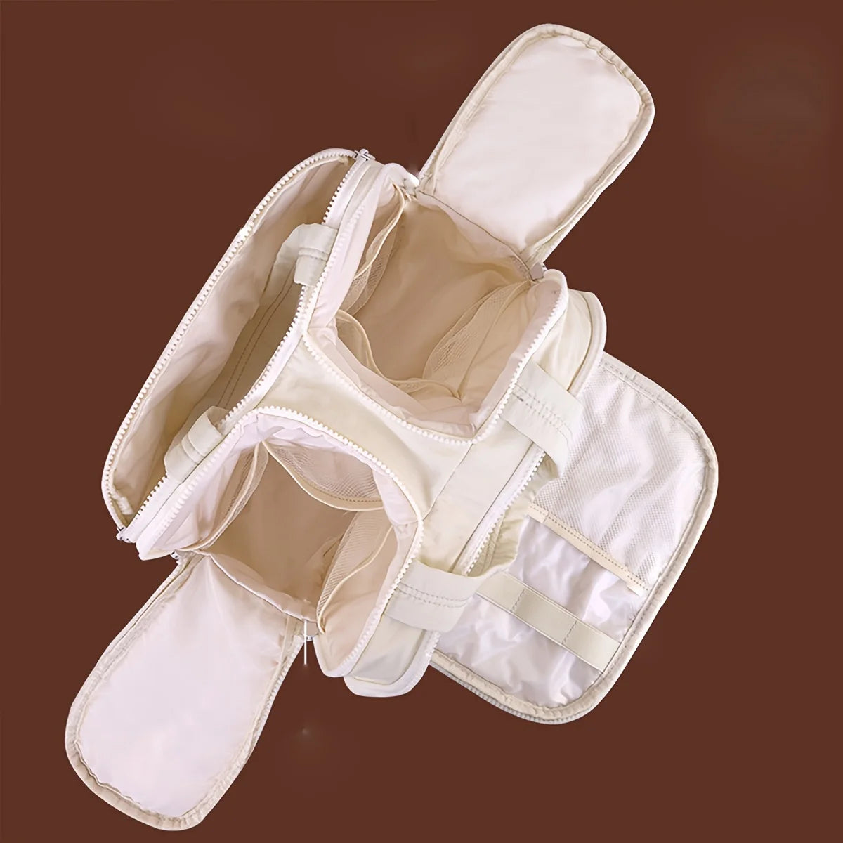 A beige portable side-zip cosmetic organizer bag with a padded interior and exterior pockets.