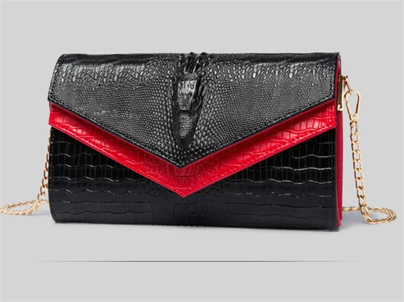 Black alligator pattern leather clutch bag with a red accent and gold chain.