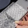 A hand holds a clear self-sealing bubble mailer bag filled with protective cushioning.