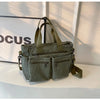 A olive green textured corduroy tote bag with adjustable straps resting on a white surface.