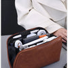 A brown leather multi-layer cable organizer pouch is shown open, displaying various electronic cables and accessories.