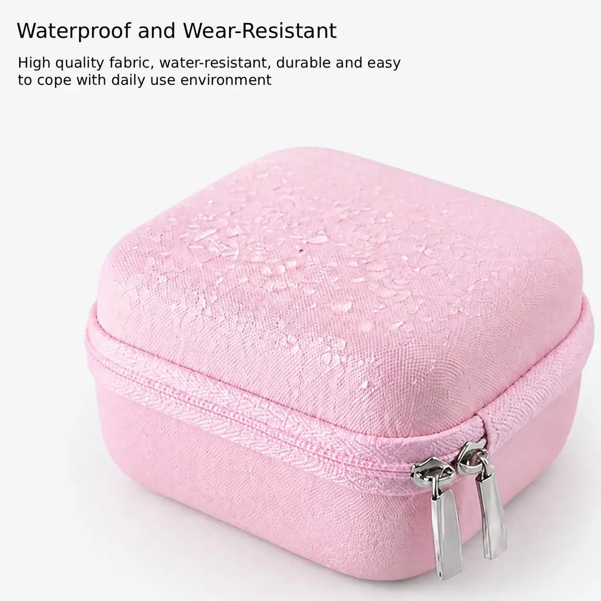 A pink durable hard shell camera travel case with a zipper visible on the front.