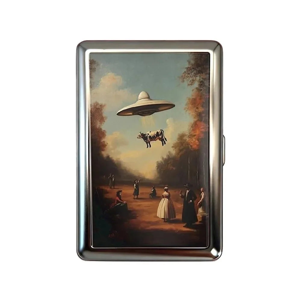 A vintage snap metal card holder with a rectangular frame and a scenic painting inside.