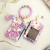 A purple and pink floral silicone bead key chain wallet with a clear window and a beaded bracelet