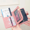 A pink multi-functional PU leather passport wallet is shown open, displaying various cards and documents.