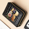 A black PU leather double-zip clutch wallet featuring a gold-toned cartoon print of a flower.