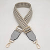 A beige and gray checkered braided nylon strap for a bag, featuring gold-toned metal hooks.