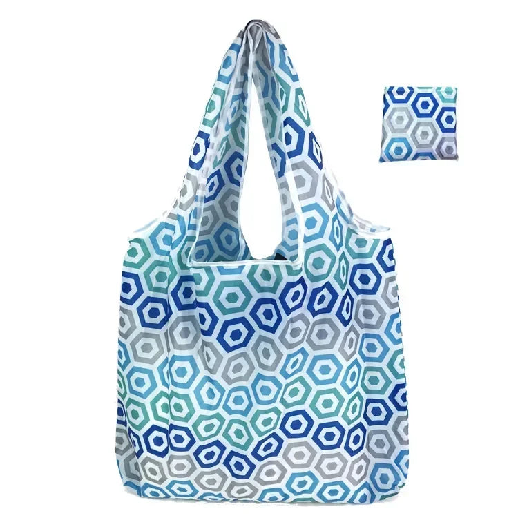 A light blue and gray geometric print foldable tote bag shown in various folds.