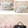 A collection of travel duffel bags in white, pink, and black featuring various sizes and materials.