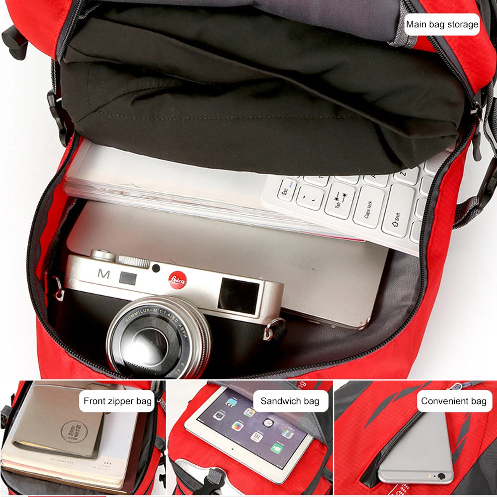 A red hiking backpack showing interior storage compartments including a laptop, camera, and sandwich bag.