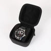 Black multi-slot travel watch organizer case with soft lining and a wristwatch inside.