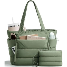 A quilted olive green puffer tote bag with pockets and a matching pouch resting on a white surface.
