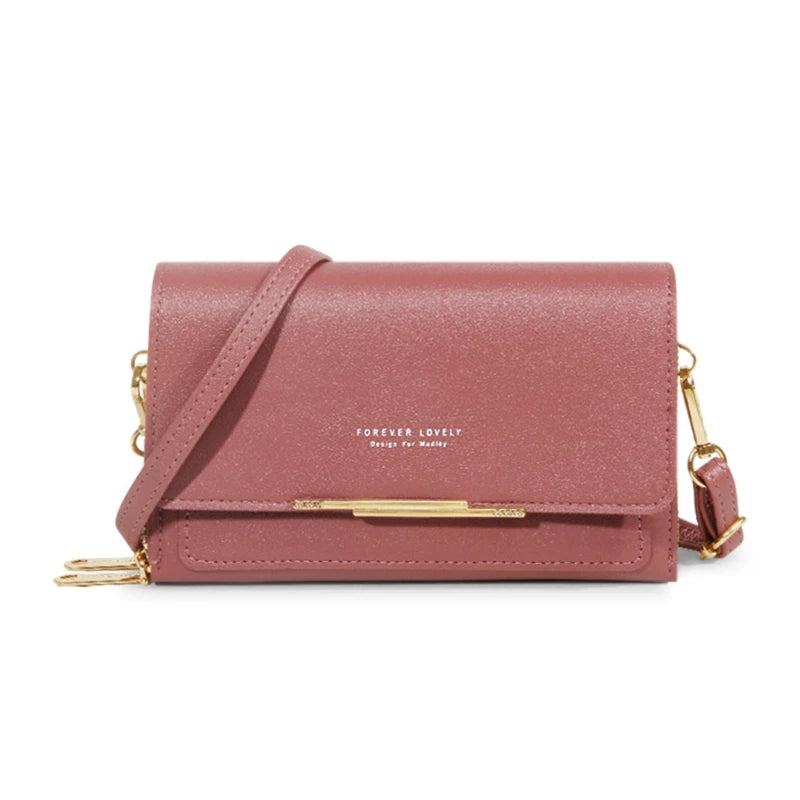 A pink leather multi-card shoulder wallet with gold hardware shown against a white background.
