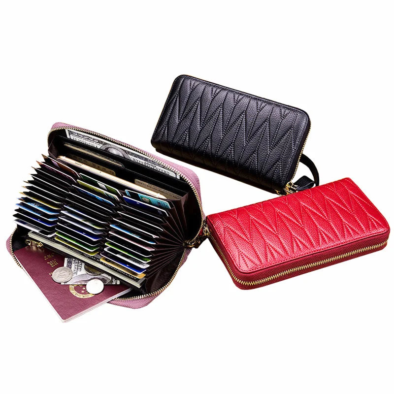 A set of two genuine leather RFID women's travel wallets, one black and one red, displayed against a white background.