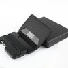 A black minimalist leather card holder with a bottle opener is shown open on a white background.