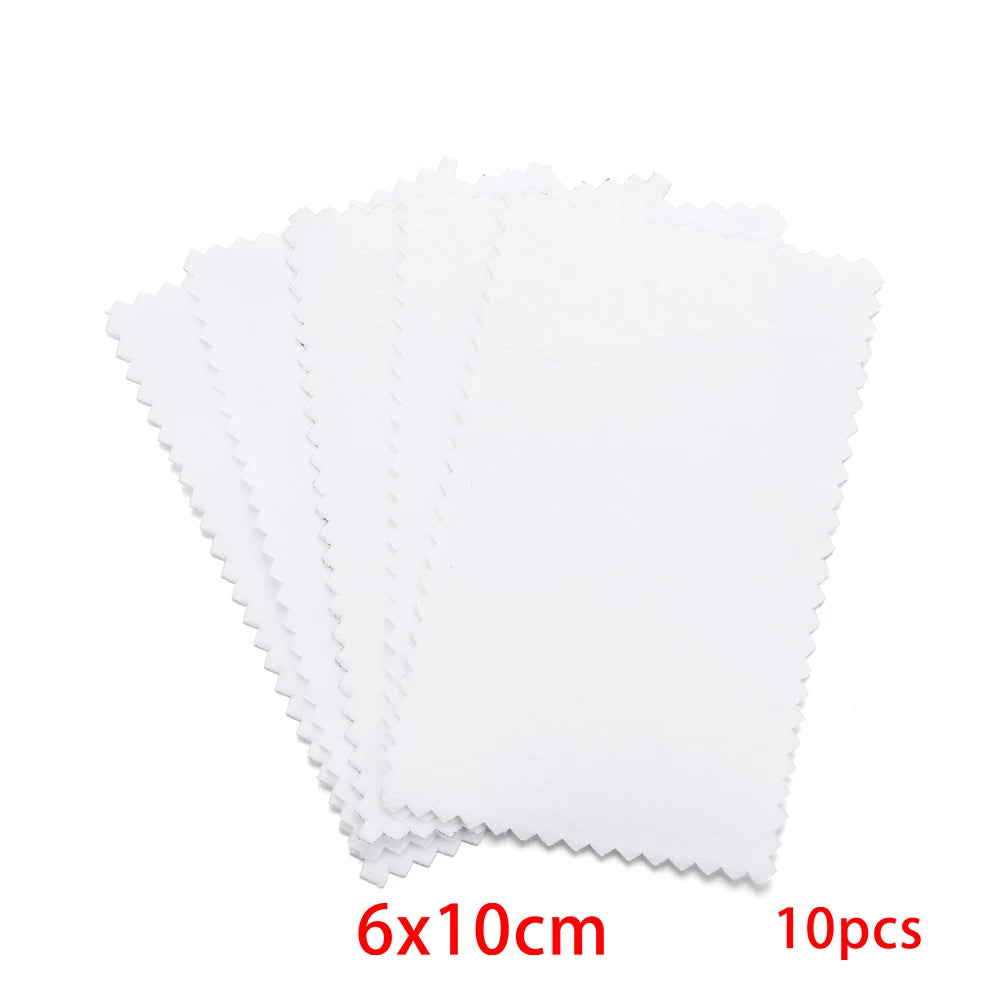 A stack of ten white polishing cloths with scalloped edges for silver and gold jewelry
