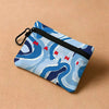 A blue and white marbled print mini coin purse with a black carabiner clip.