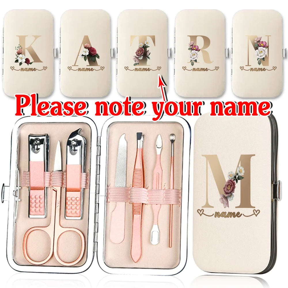 A set of customizable stainless steel nail clippers and tools in a light beige case with initial letters and name personaliza