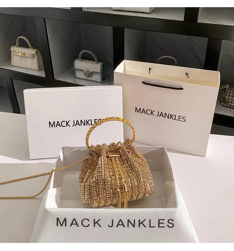Gold crystal-embellished evening clutch with chain displayed in a white box.