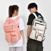 A person is holding a large capacity travel backpack in pink and white colors.