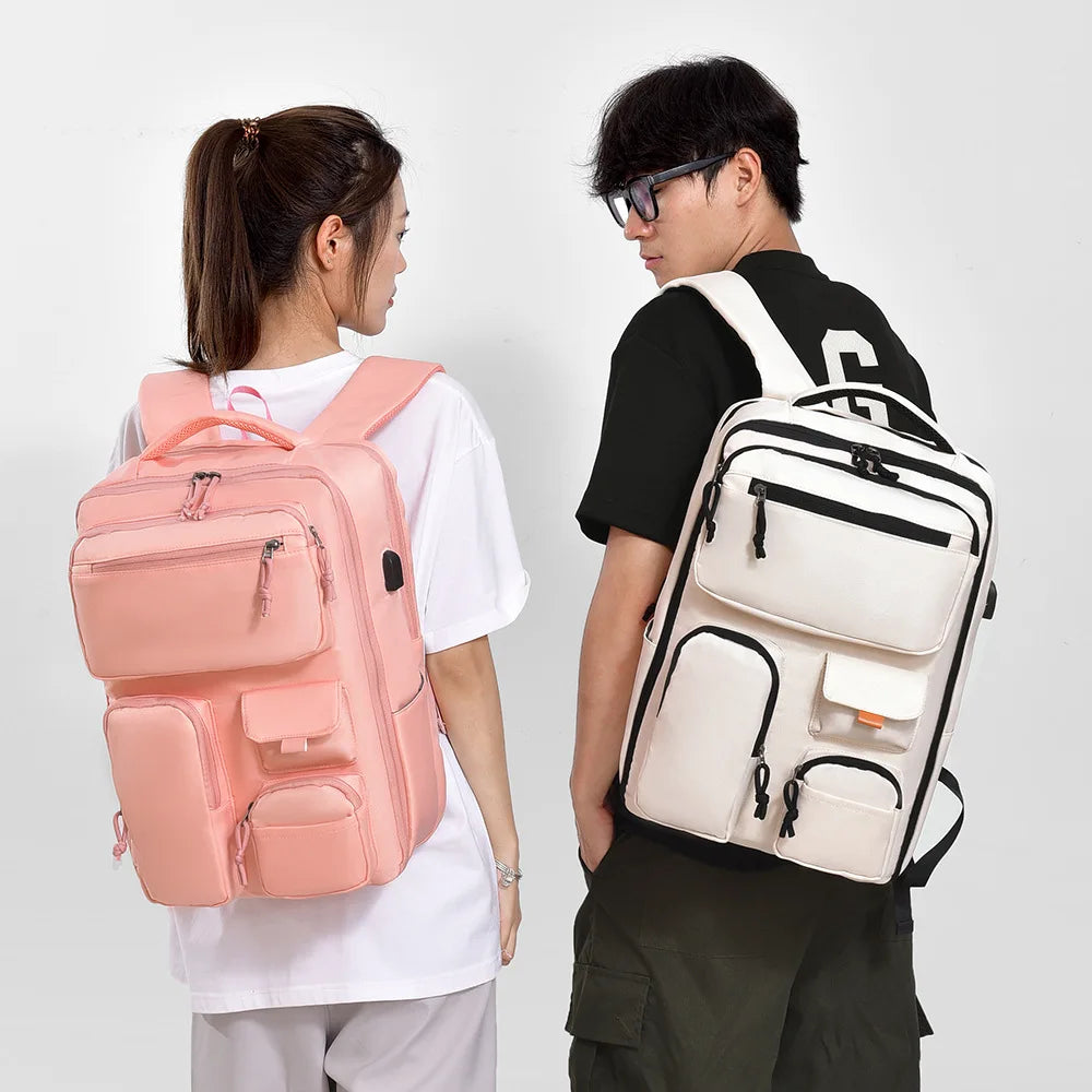 A person is holding a large capacity travel backpack in pink and white colors.