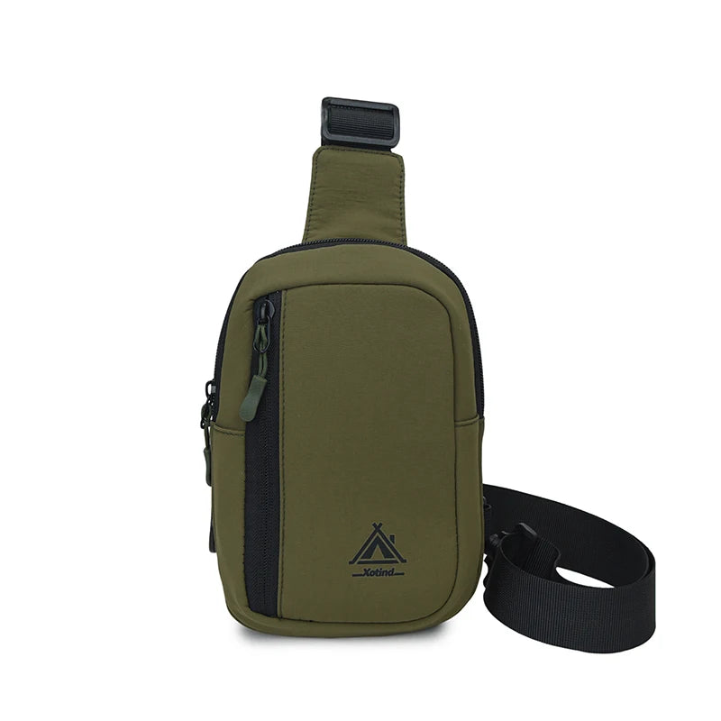 Olive green nylon sling crossbody bag with a black strap and attached to a black strap.
