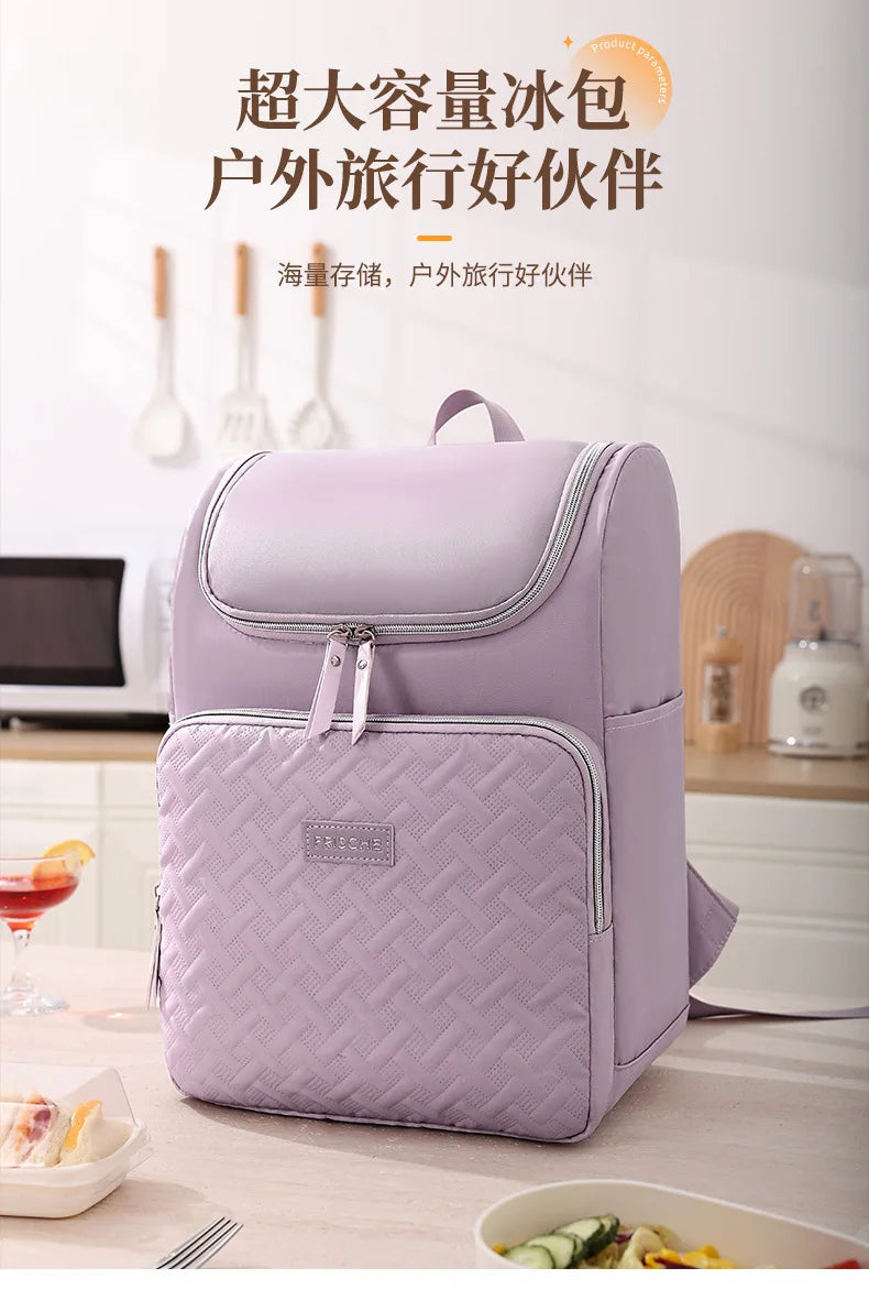 A purple insulated picnic cooler backpack is shown on a table with food items nearby.