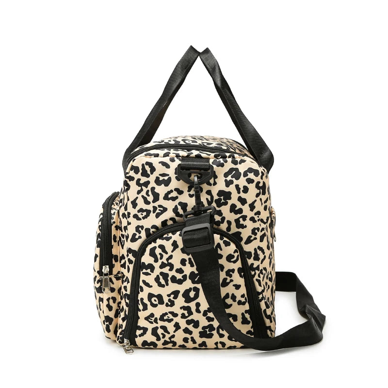 A beige leopard print travel duffel bag with black straps and a shoe compartment.