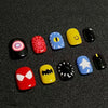A set of 30 cute cartoon press-on nails in various colors including black, yellow, blue, and red designs.