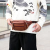 Un homme portant un pull tricoté crème et un pantalon noir tient un sac à taille pour hommes en cuir véritable brun.