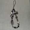 A black and white leopard print bowknot phone lanyard featuring heart-shaped beads.