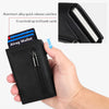 A black minimalist magnetic wallet holding several bank cards and a wallet box.